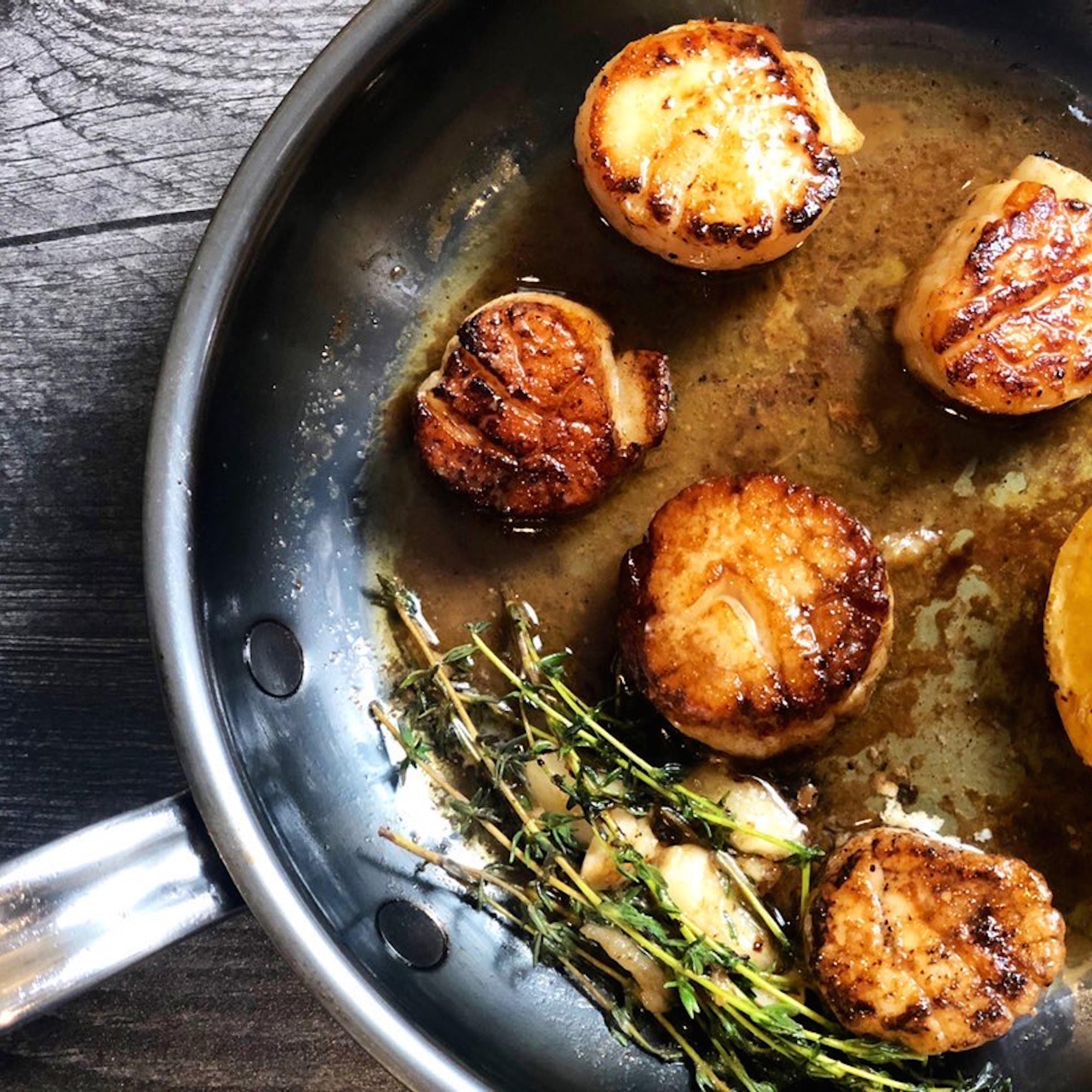Scallops are cooked in a fry pan.