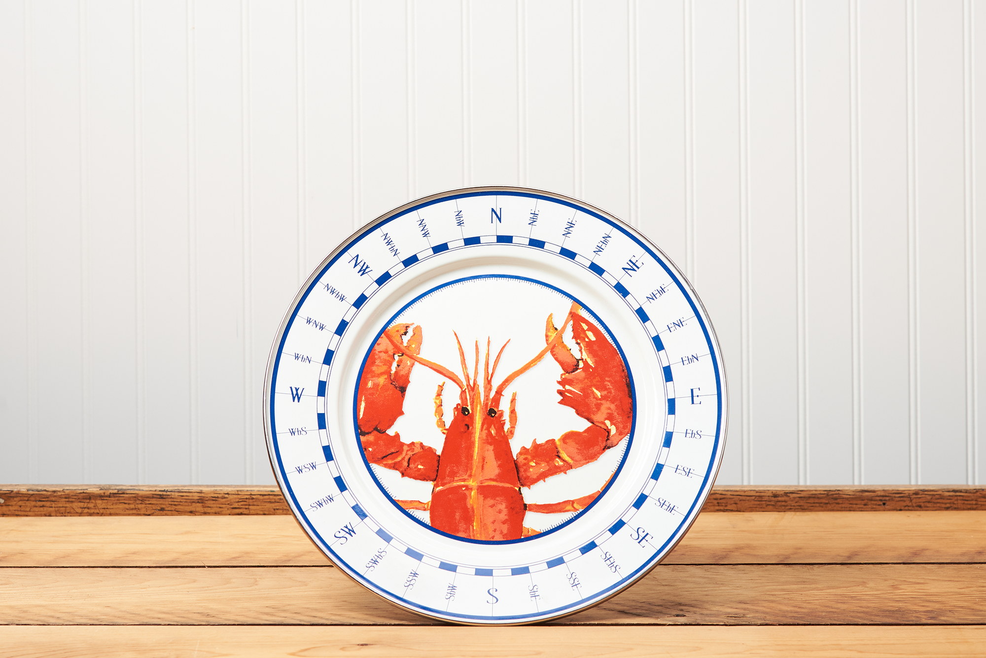 A Golden Rabbit Lobster Charger sitting on a brown wooden table.