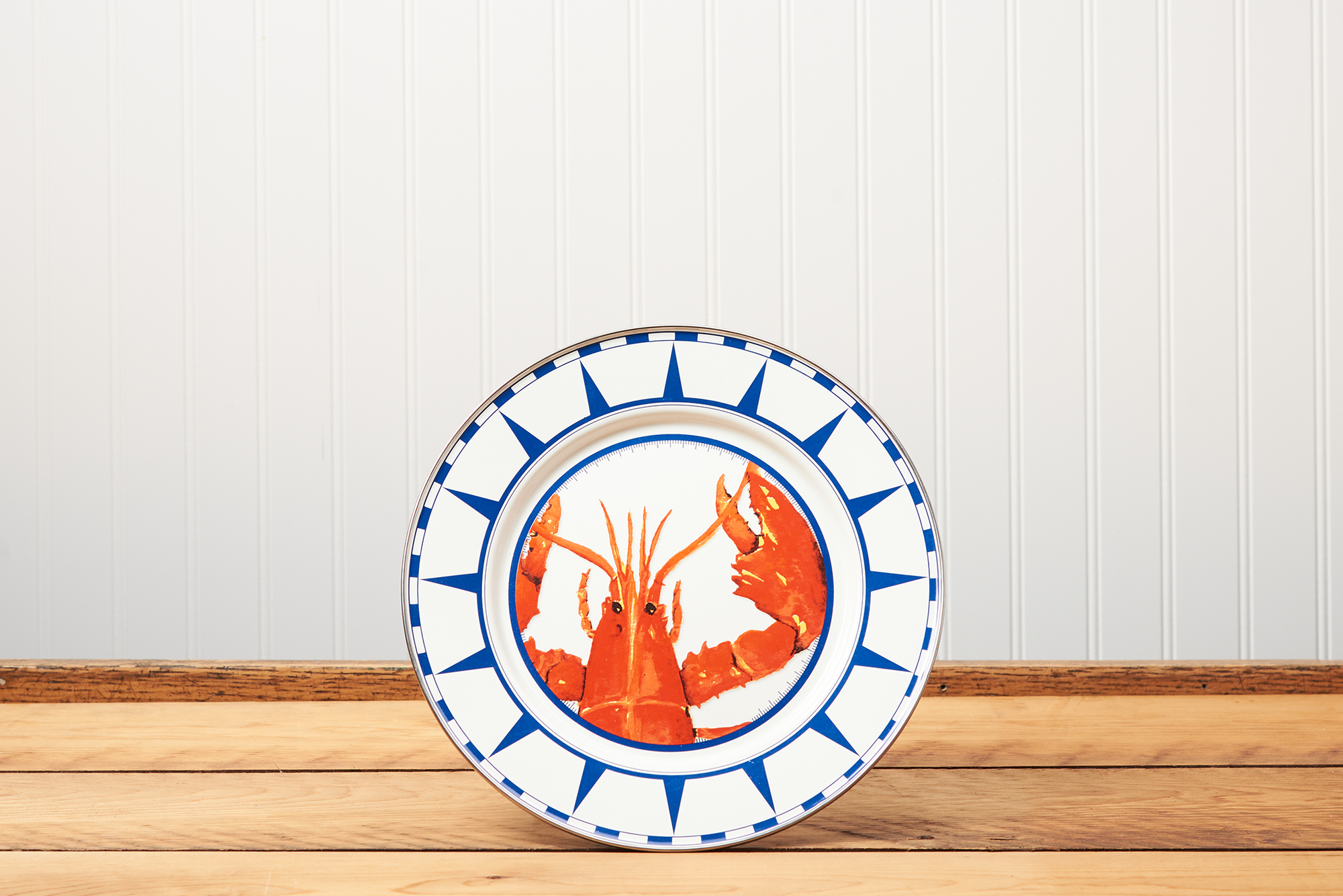 A Golden Rabbit Lobster Dinner Plate sitting on a brown wooden table.