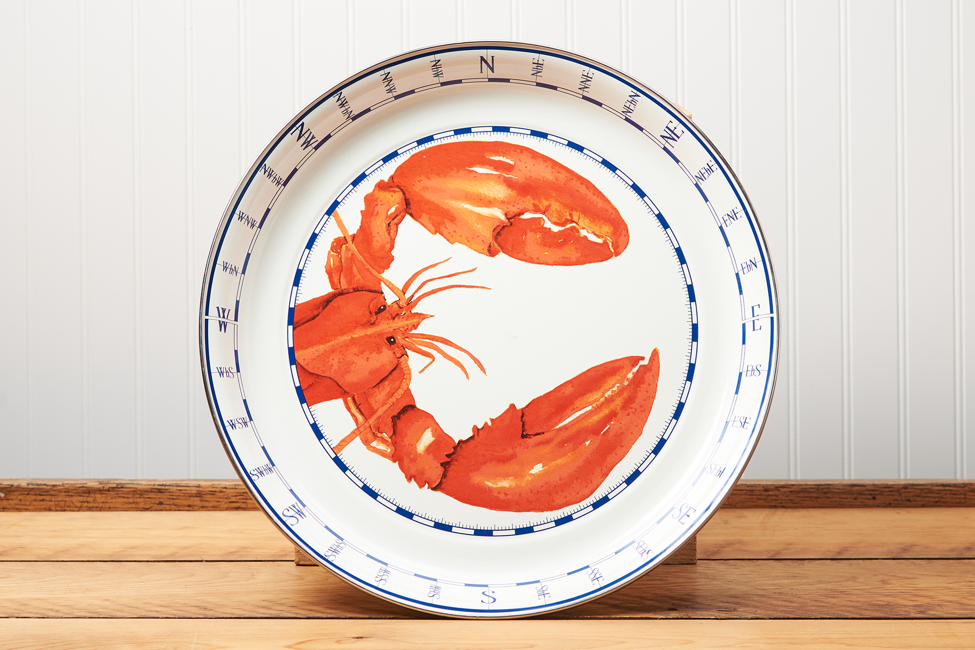 A Golden Rabbit Lobster Medium Tray sitting on a brown wooden table.