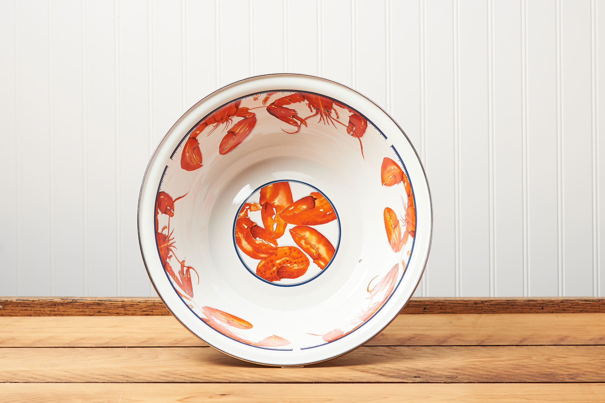 A Golden Rabbit Lobster Serving Bowl sitting on a brown wooden table.
