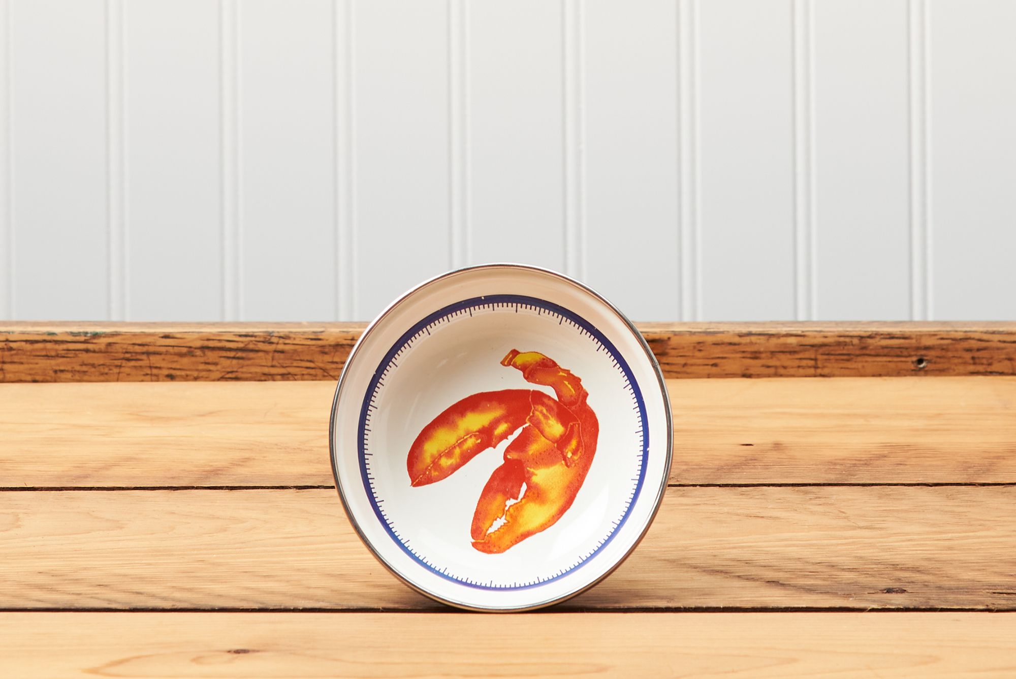 A Golden Rabbit Lobster Tasting Dish sitting on a brown wooden table.