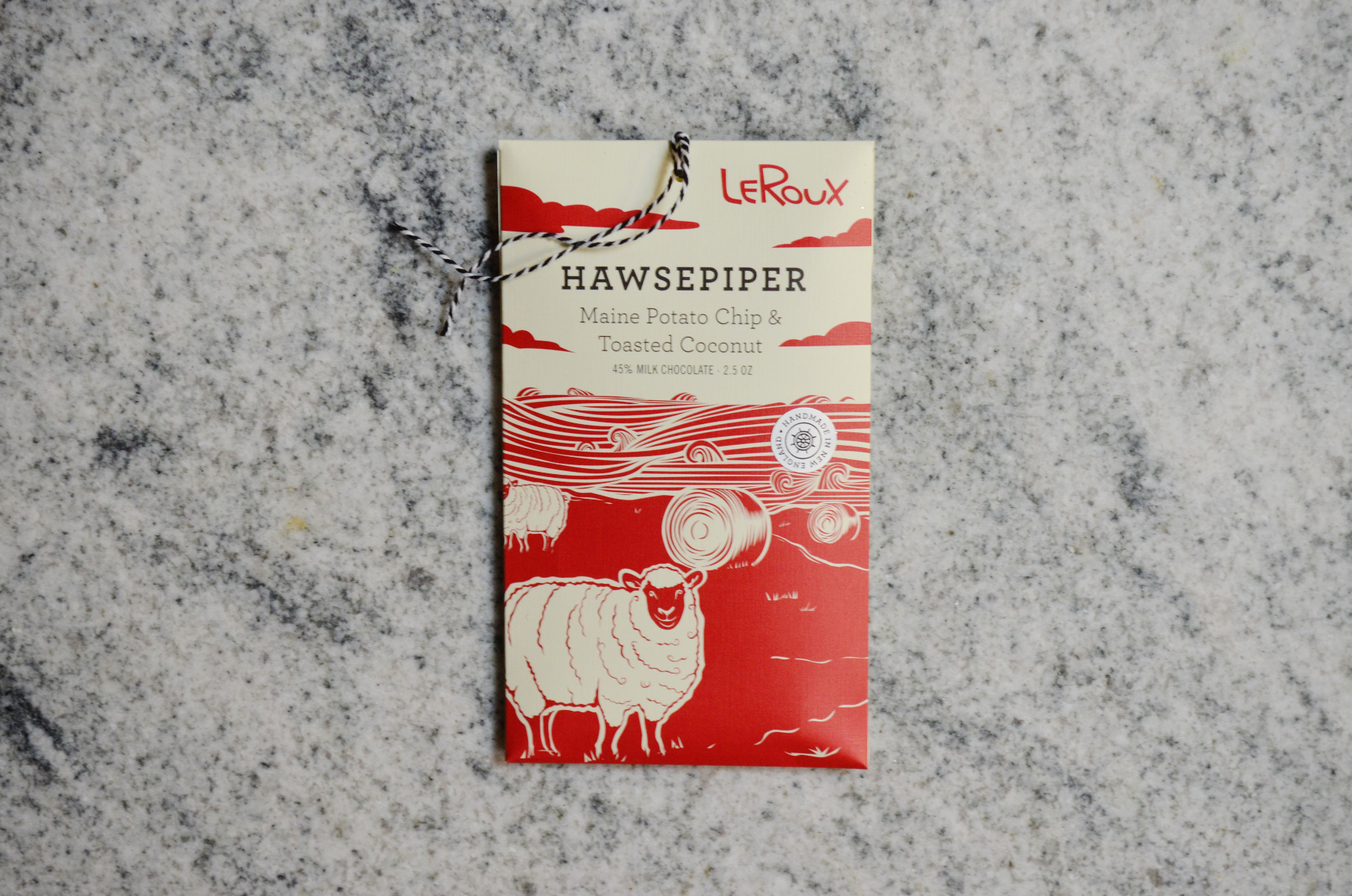 LeRoux Hawsepiper chocolate bar with red wrap and sheep design on marble background