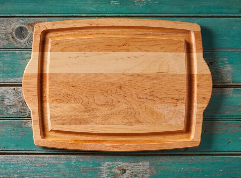 Wooden serving tray on turquoise wooden background