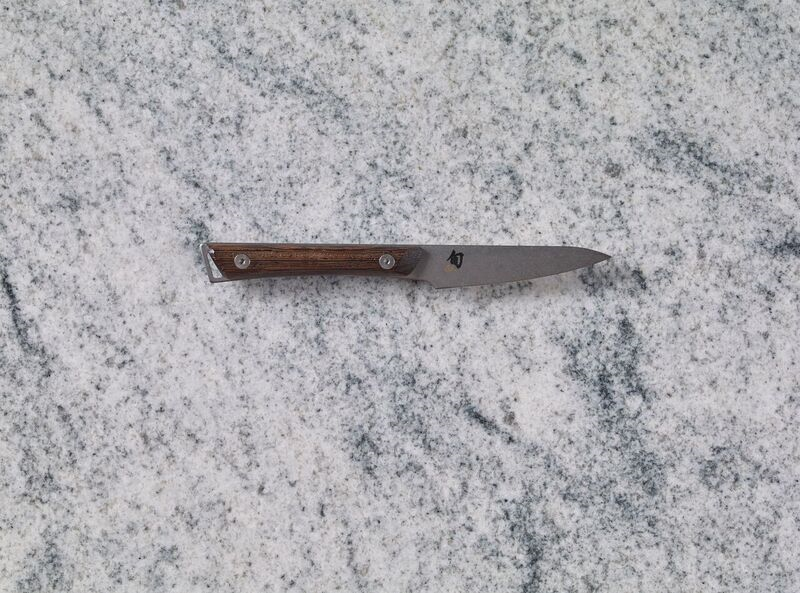 A Shun Kanso 3.5" Paring Knife on a marble countertop.