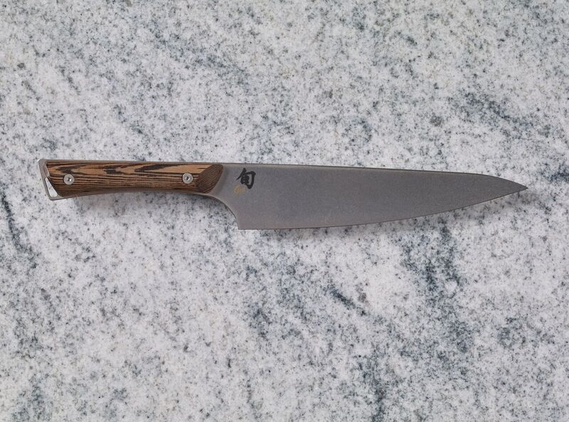 A Shun Kanso 8" Chef's Knife on a marble countertop.