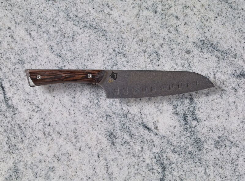 A Shun Kanso 7" Hollow Ground Santoku on a marble countertop.