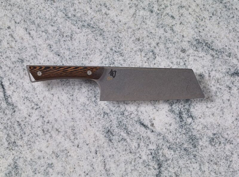A Shun Kanso 7" Asian Utility Knife on a marble countertop.