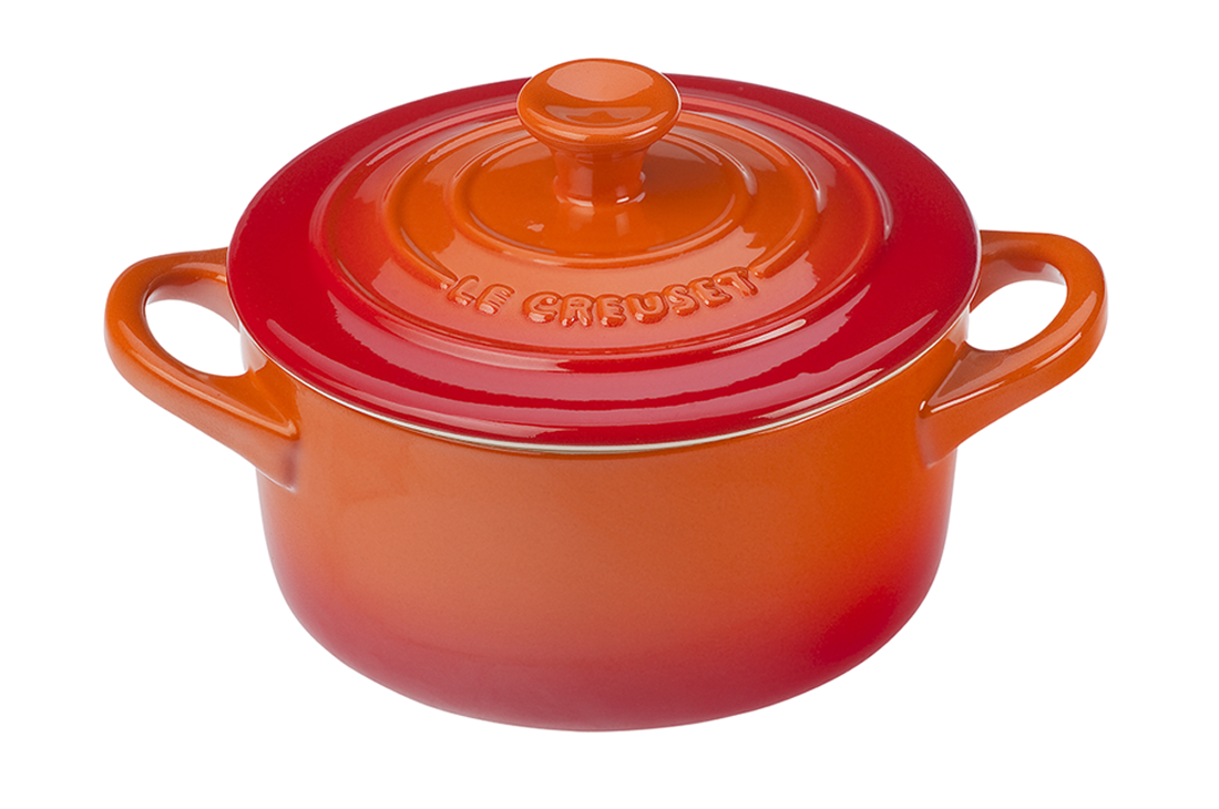 Red Le Creuset cast iron Dutch oven on white background