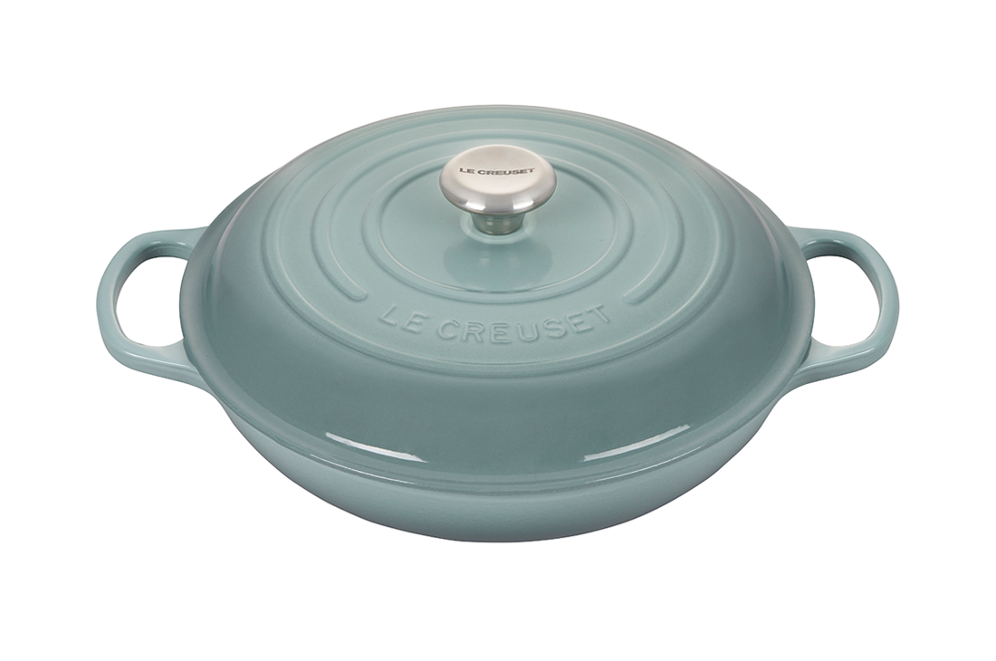 Duck egg blue enameled cast iron casserole dish by Le Creuset.