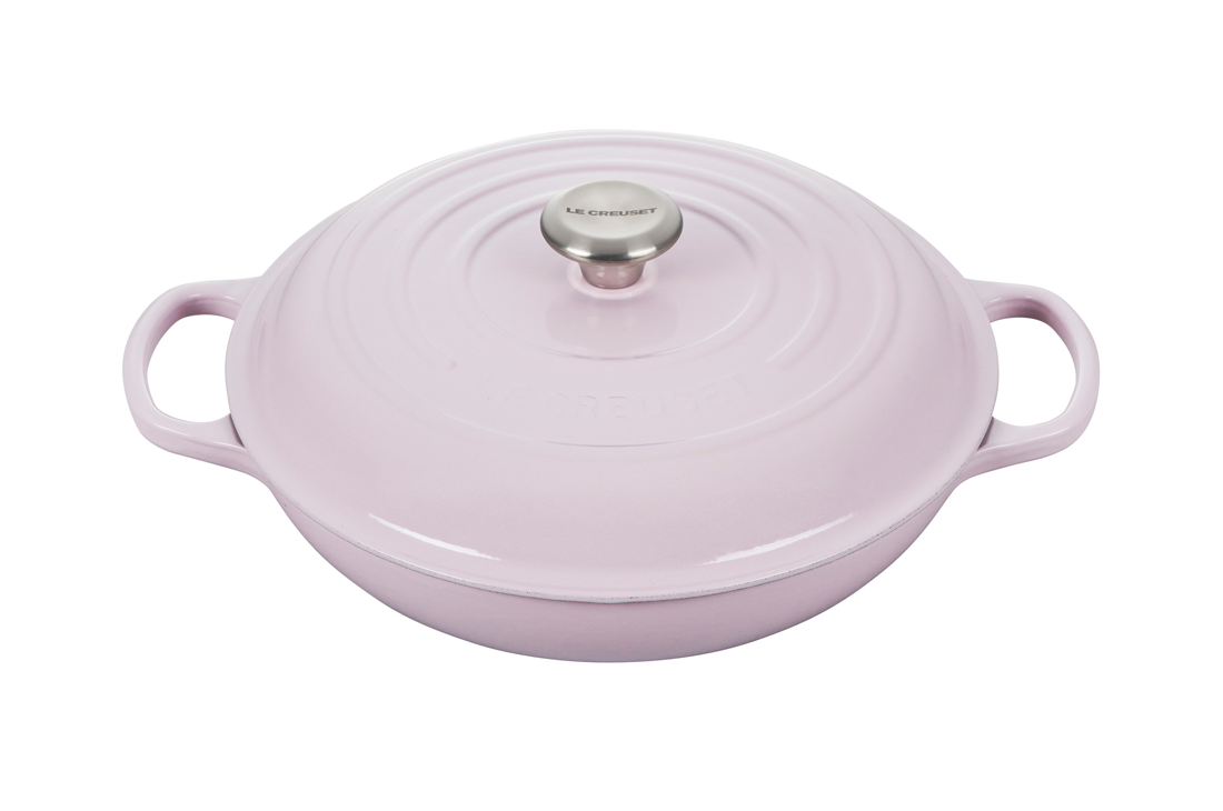 Lavender round cast iron casserole dish with lid on white background