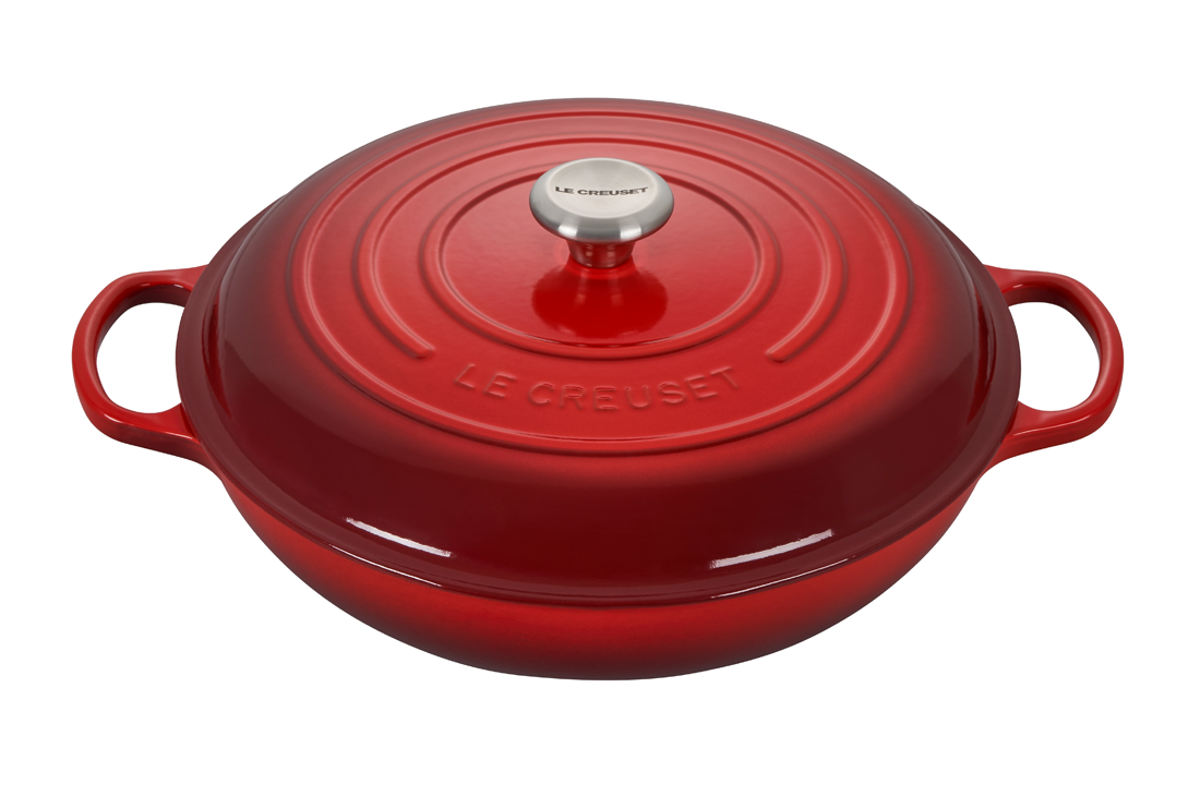 Red Le Creuset round cast iron Dutch oven on white background