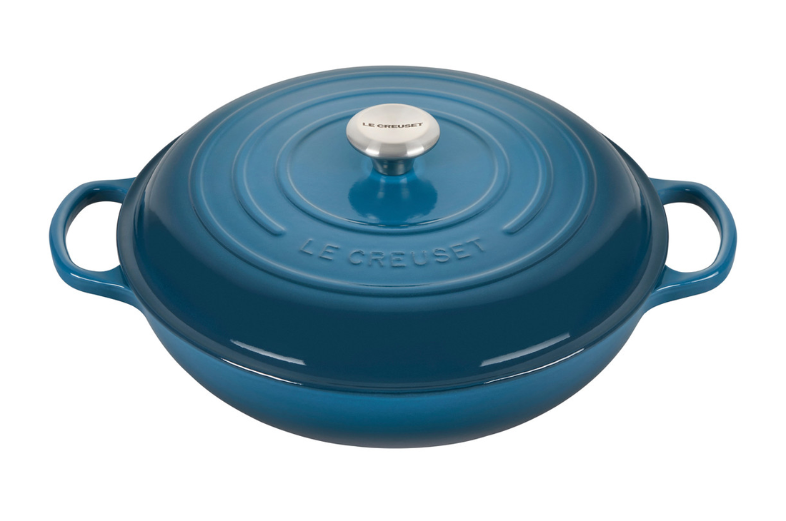 Blue cast iron Dutch oven isolated on white background