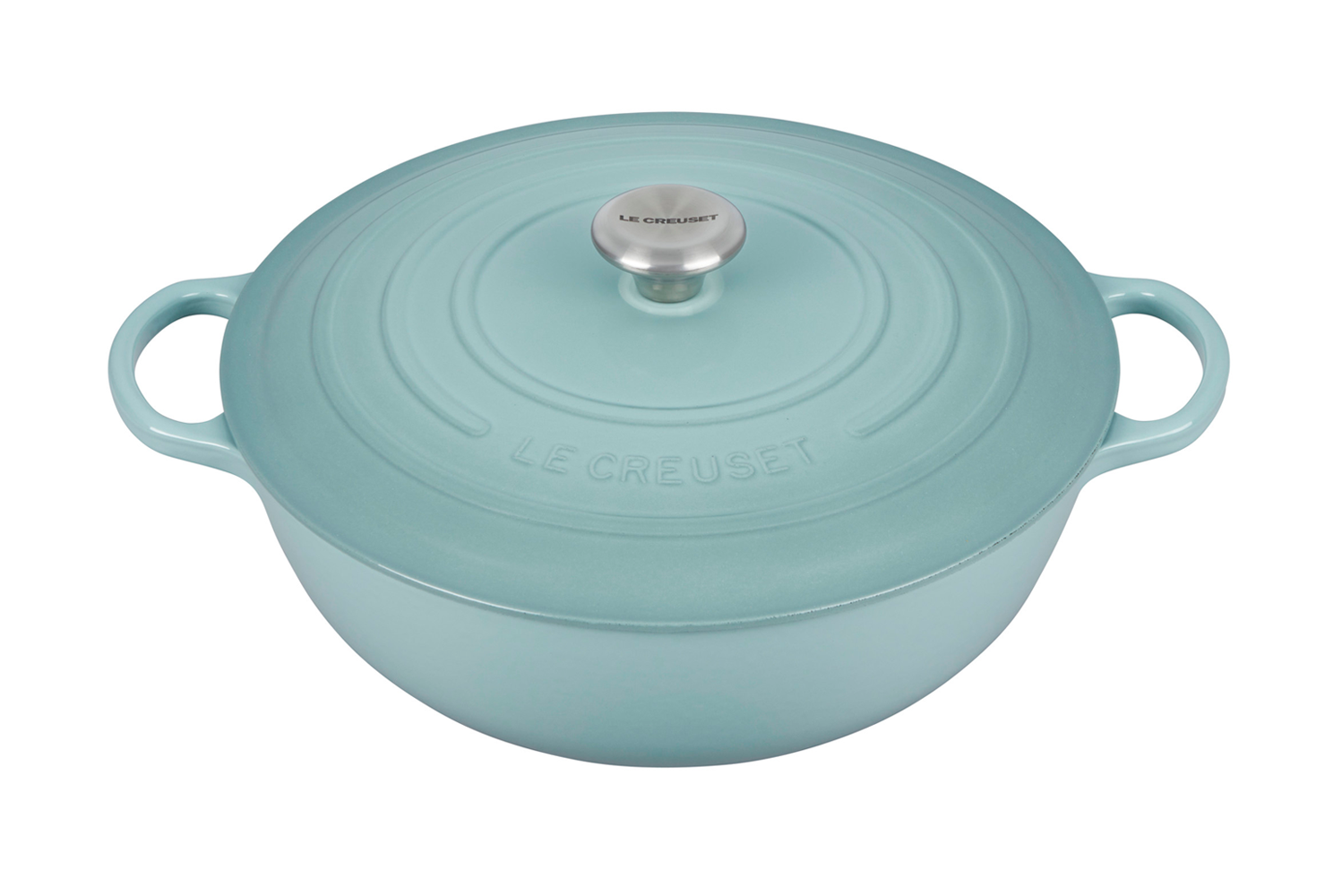 Blue enameled cast iron Dutch oven by Le Creuset on white background