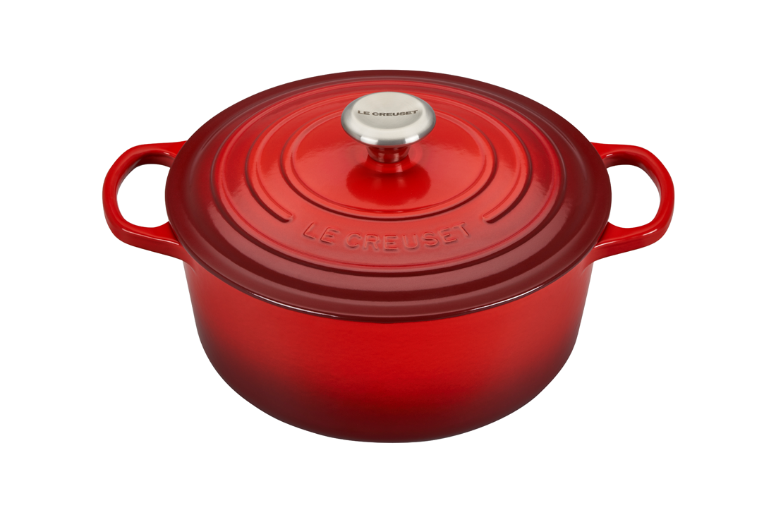 Red Le Creuset cast iron Dutch oven on white background