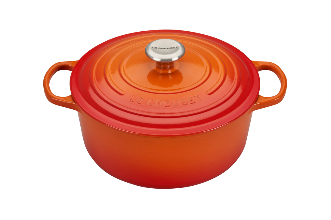 Orange Le Creuset cast iron Dutch oven on white background