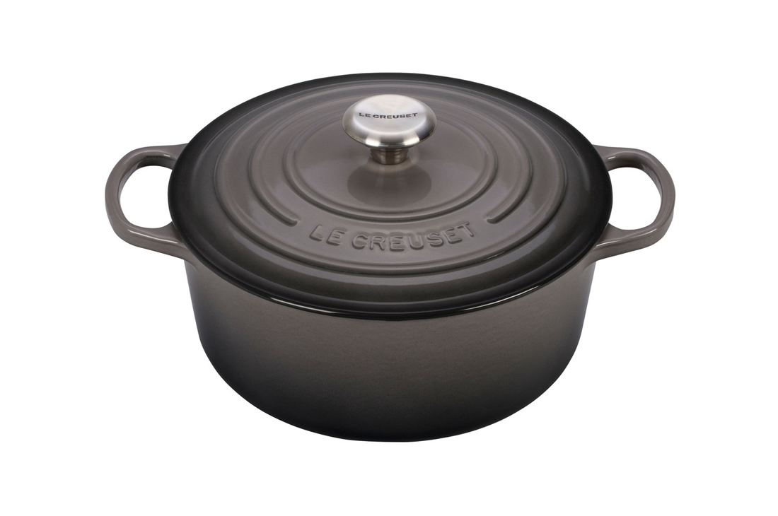 Le Creuset black cast iron Dutch oven with lid on white background