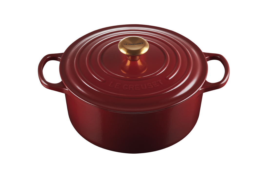 Red Le Creuset cast iron Dutch oven on a white background