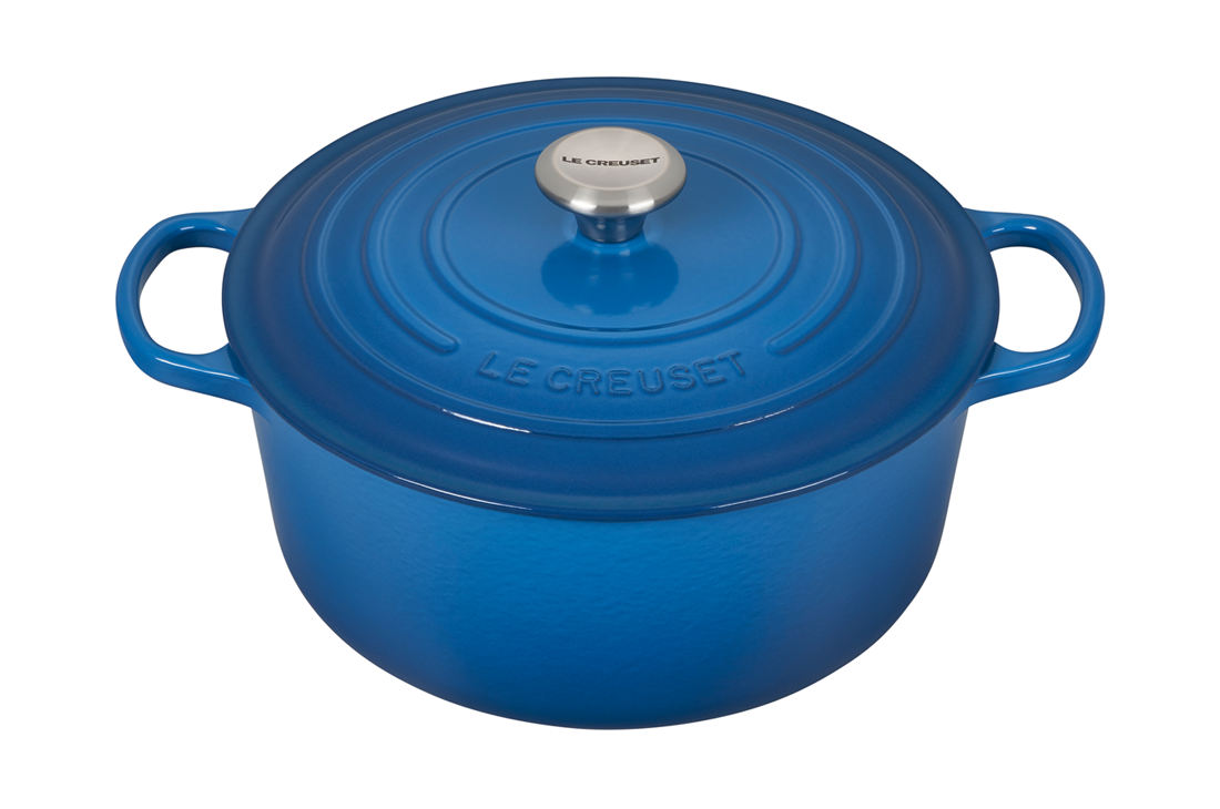 Blue enameled cast iron Dutch oven isolated on white background.