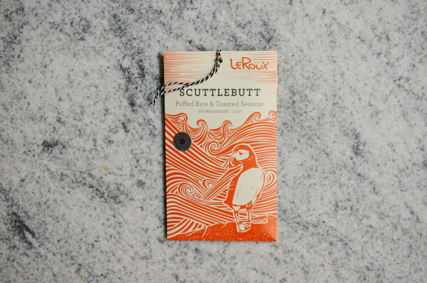 LeRoux Scuttlebutt chocolate bar with puffed rice and sesame on marble surface