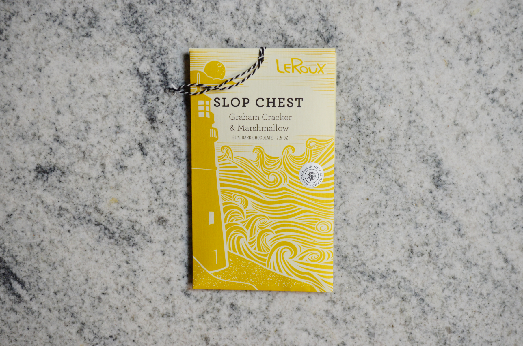 LeRoux Slop Chest chocolate bar with graham cracker and marshmallow on marble surface.