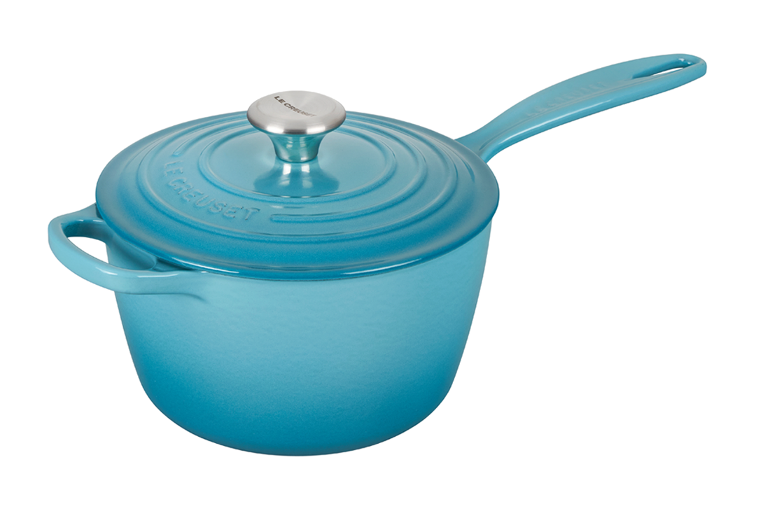 Blue enameled cast iron saucepan with lid on white background