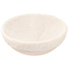 Beige fabric bread proofing basket on white background