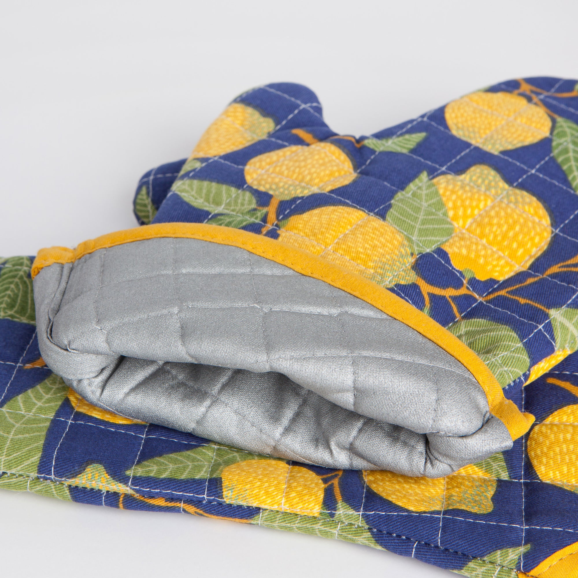 A lose up of the interior lining of Now Designs Lemons Oven Mitt.