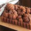 Fresh baked cinnamon swirl bread on wooden board with knife
