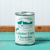 A can of Bar Harbor Foods Lobster Corn Chowder sits on a turquoise wooden table.