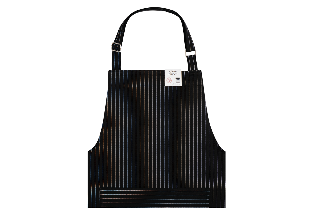 A Now Designs Black Pinstripe Apron over a white background.