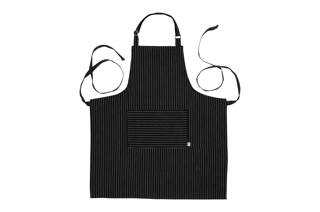 A Now Designs Black Pinstripe Apron over a white background.