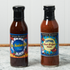 Two bottles of Captain Mowatt's BBQ Sauce sits on a marble countertop. The flavors are Bar Harbor-Que and
Shipyard Beer-B-Que.