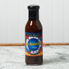 A bottle Captain Mowatt's Bar Harbor-Que Sauce of sits on a marble countertop.