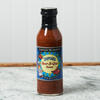 A bottle Captain Mowatt's Shipyard Beer-B-Que Sauce of sits on a marble countertop.