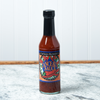 A bottle of Captain Mowatt's Canceaux Sauce sits on a marble countertop.