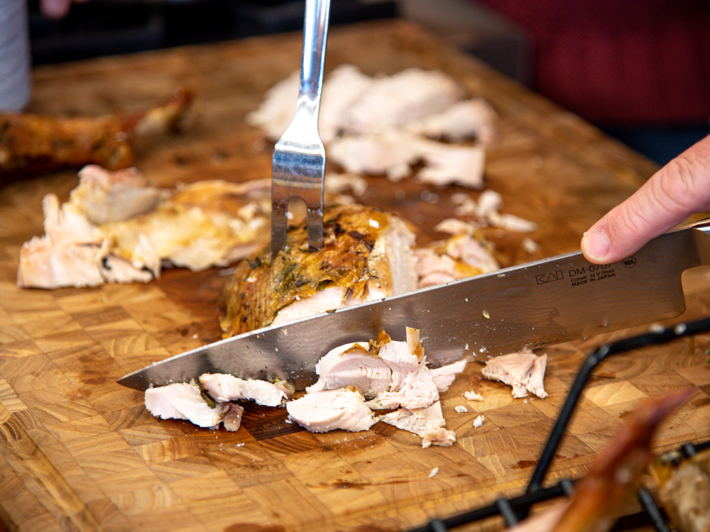 A turkey is carved on a wooden cutting board.