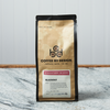A bag of Coffee By Design Blackout coffee sits on a marble countertop.