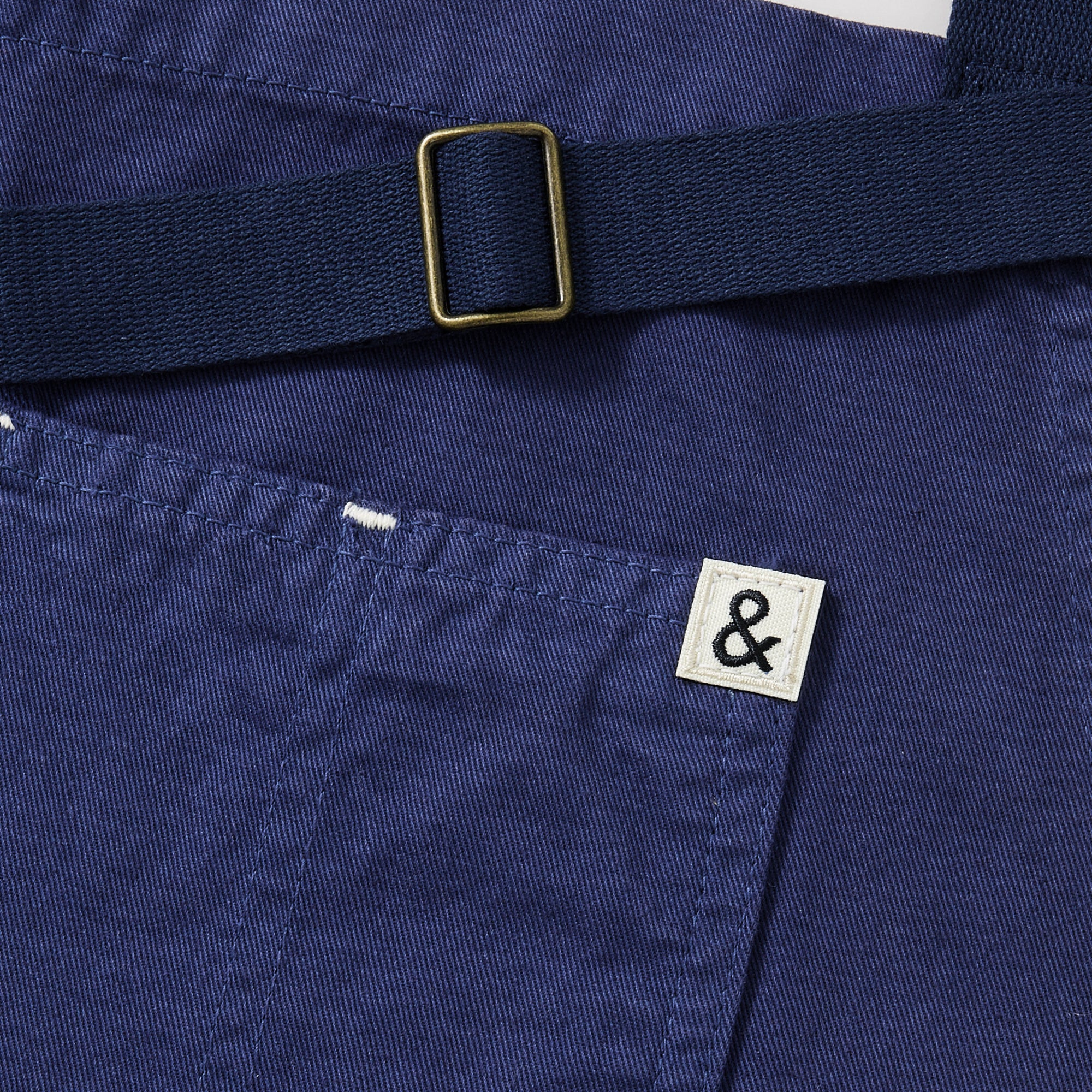 A close up shot of a Hedley & Bennett French Blue Essential Apron.
