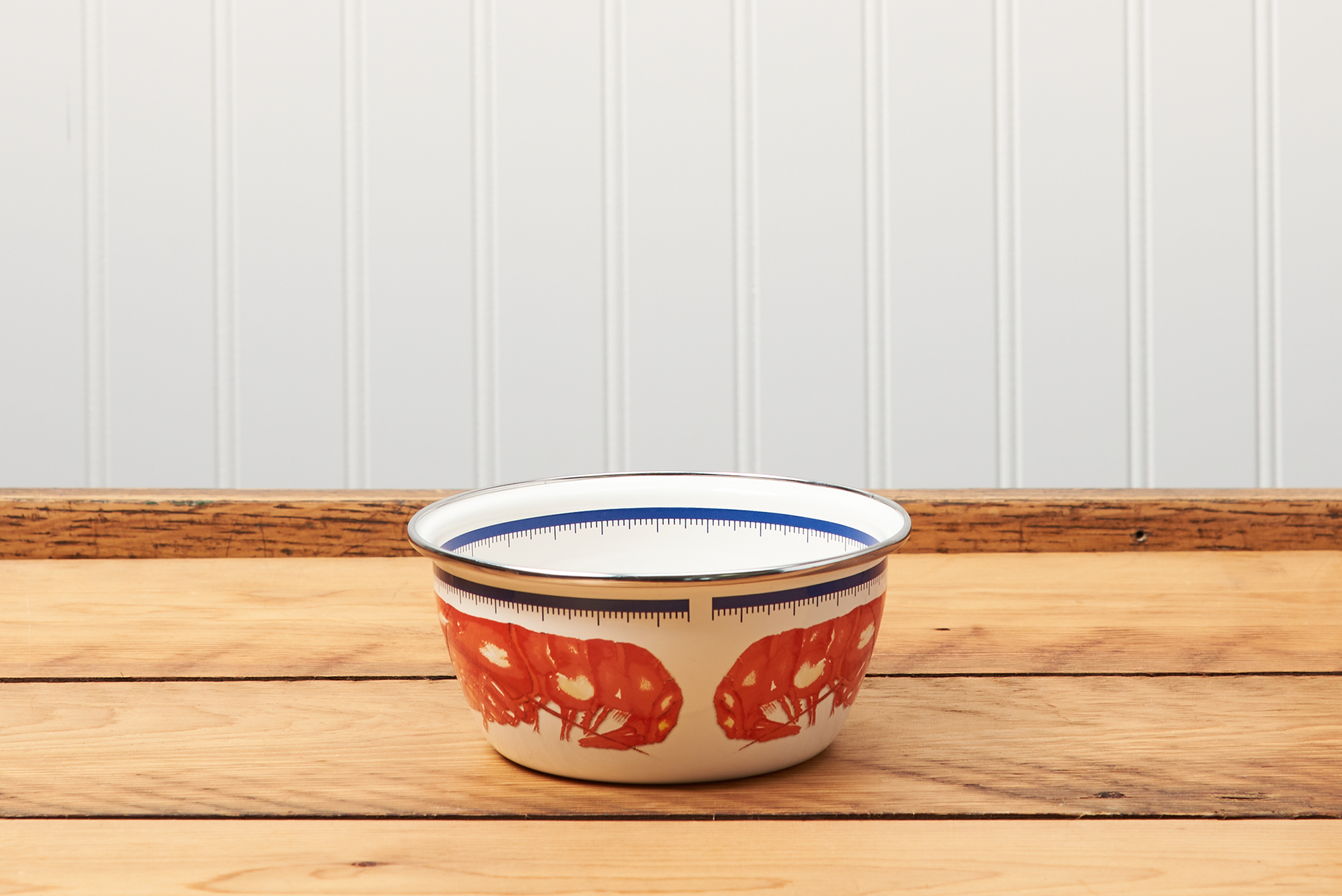 A Golden Rabbit Lobster Salad Bowl sitting on a brown wooden table.