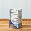 A side-facing view of a box of Greek Sea Salt Flakes sitting on a wooden table.