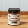 A jar of Gryffon Ridge Blackening Seasoning sits on a wooden tabletop.