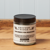 A jar of Gryffon Ridge Fair Winds Fish Seasoning sits on a wooden tabletop.
