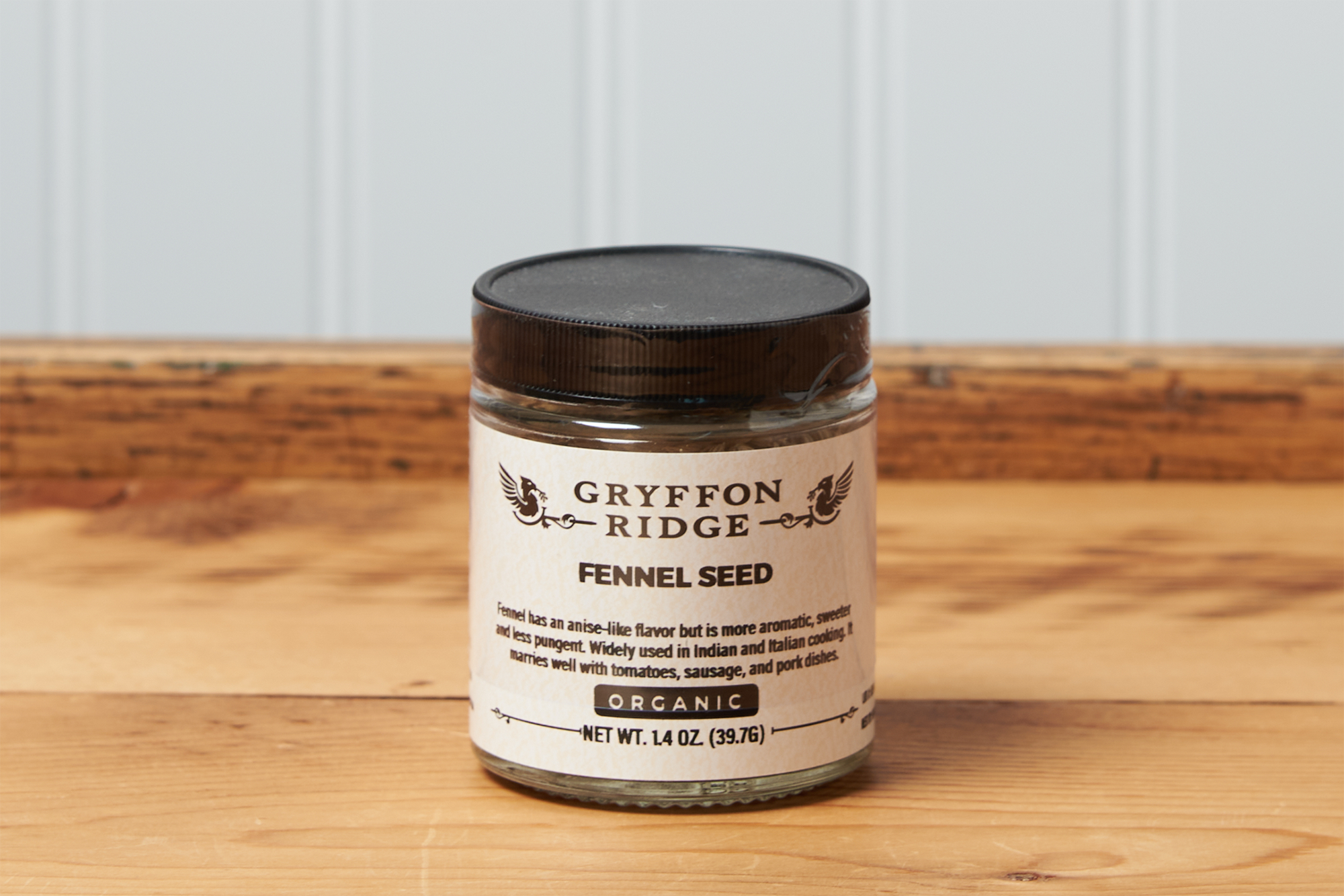 A jar of Gryffon Ridge Fennel Seed sits on a wooden tabletop.