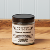 A jar of Gryffon Ridge Herbs de Provence sits on a wooden tabletop.