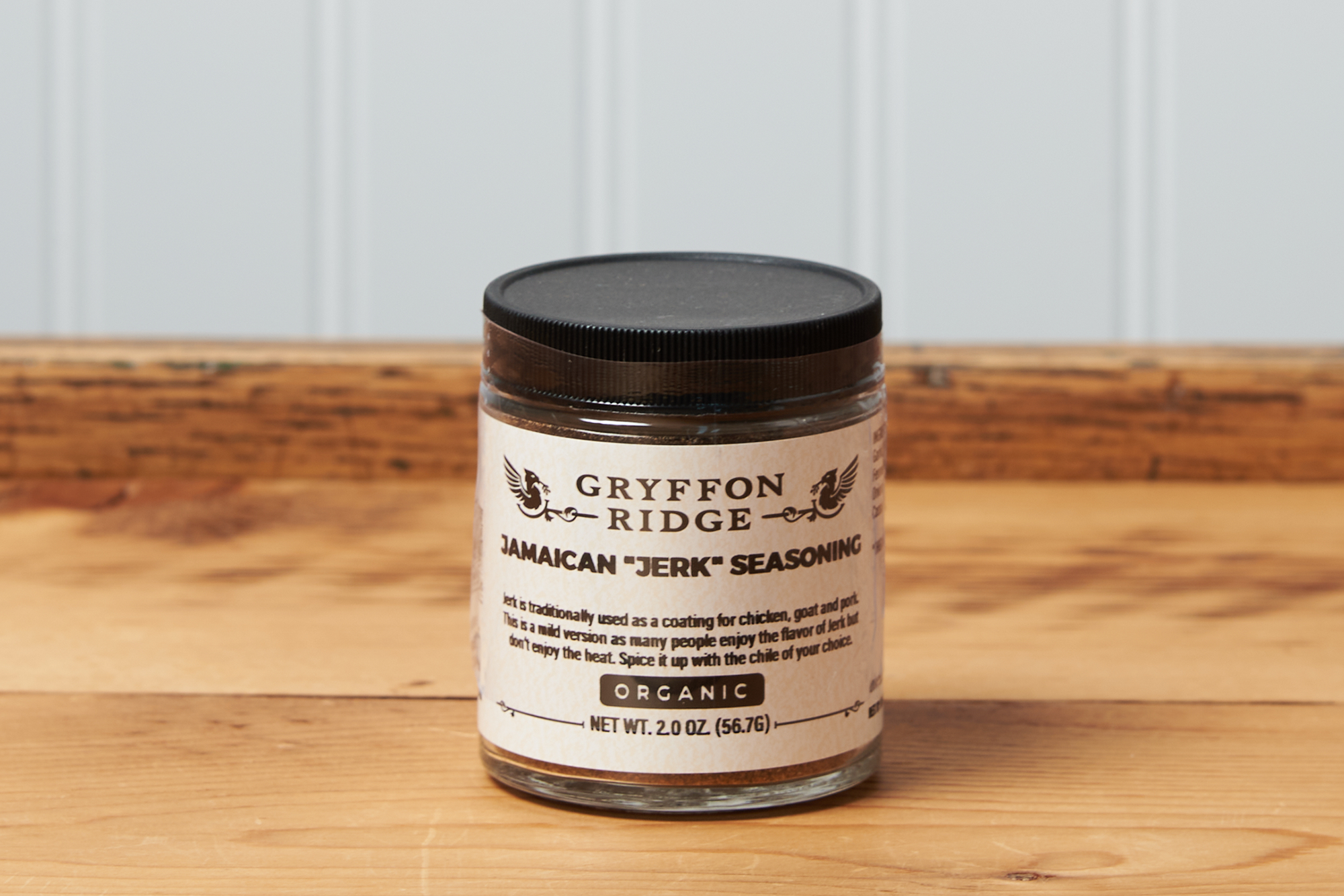 A jar of Gryffon Ridge Jamaican “Jerk” Seasoning sits on a wooden tabletop.