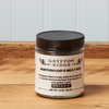 A jar of Gryffon Ridge Northwoods Meat Rub sits on a wooden tabletop.