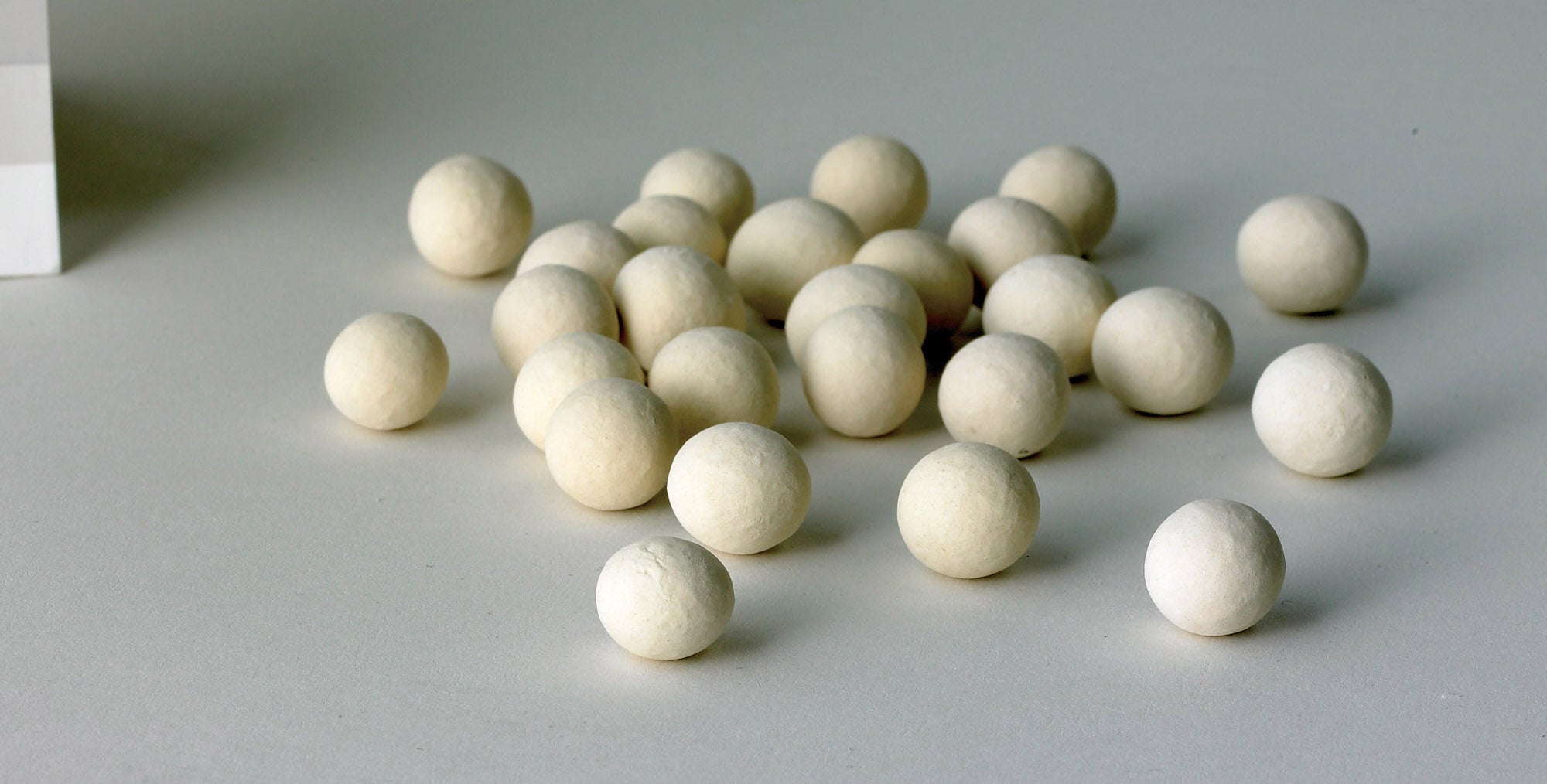 A close up shot of Mrs. Anderson's Baking Ceramic Pie Weights on a gray countertop.