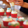 Person frosting cupcakes using Mrs. Anderson's Baking Pastry Decorating Tips.
