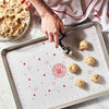 Person scooping cookie dough onto a King Arthur Baking Company Cookie Mat.